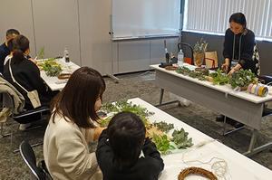 Participants gathering to make herb wreaths.