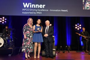 The award was presented by IAPCO President, Sarah Markey-Hamm to Nia Zárate Angarita who received it on behalf of her colleague Audrey Alloul, Chief Digital Officer at Kenes Group